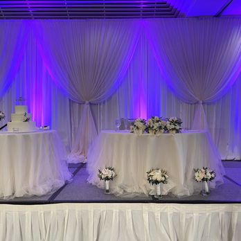 The Wedding Linen Company - Pipe & drape with bunch accents. Ivory matte satin linens and ivory tulle overlay. Another fave! - Party Equipment Rentals Near Me - Pearl City, Hawaii The Wedding Linen Company - Pipe & drape with bunch accents. Ivory matte satin linens and ivory tulle overlay. Another fave! - Party Equipment Rentals Near Me - Pearl City, Hawaii