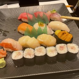 Assorted special sushi of the night with a few missing pieces of nigiri and a traditional yellowtail roll Assorted special sushi of the night with a few missing pieces of nigiri and a traditional yellowtail roll