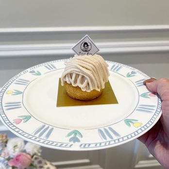 First Bite - a person holding a plate with a cupcake on it - Desserts Near Me - Richmond, British Columbia