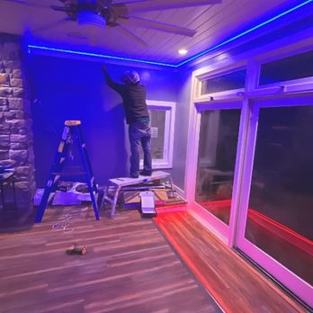 Legendary Construction Services - a man on a ladder working on a ceiling fan - General Contractors Near Me Legendary Construction Services - a man on a ladder working on a ceiling fan - General Contractors Near Me
