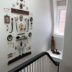 Affairs of the Art - Whole wall of metal art and artifacts from around the world.