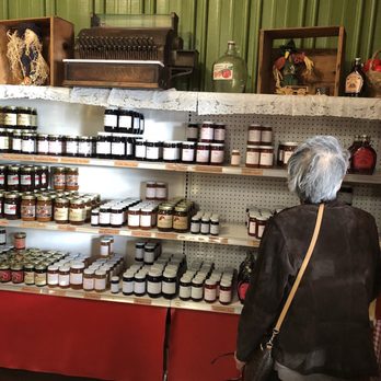 Okaw Valley Orchard - a woman looking at jars of jams - Pick Your Own Farms Near Me - Sullivan, Illinois Okaw Valley Orchard - a woman looking at jars of jams - Pick Your Own Farms Near Me - Sullivan, Illinois