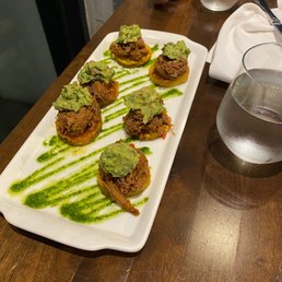 a plate of appetizers on a wooden table