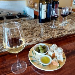 White imported wine with bread olives and oil.
