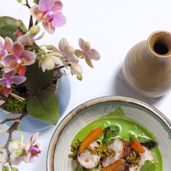 Villa Taverna - a plate of food and a vase of flowers - Italian Near Me - San Francisco, California Villa Taverna - a plate of food and a vase of flowers - Italian Near Me - San Francisco, California