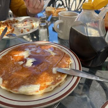 Alpine Coffee Shop Restaurant - Pancake stack and the jug of syrup they serve with it - American Near Me - Big Bear Lake, California Alpine Coffee Shop Restaurant - Pancake stack and the jug of syrup they serve with it - American Near Me - Big Bear Lake, California