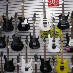 A wide selection of guitars available for sale.