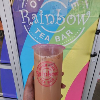 Over The Rainbow Tea Bar - a hand holding a cup of iced tea - Ice Cream & Frozen Yogurt Near Me - Issaquah, Washington Over The Rainbow Tea Bar - a hand holding a cup of iced tea - Ice Cream & Frozen Yogurt Near Me - Issaquah, Washington