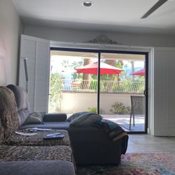 Sullivan's Shutter & Stone Factory - Living room shutters fully open to patio