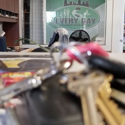 In the office sitting at the counter, my keys and their logo in the background In the office sitting at the counter, my keys and their logo in the background
