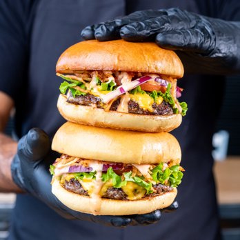PINCHO - a man holding a stack of hamburgers - Burgers Near Me - Miami, Florida PINCHO - a man holding a stack of hamburgers - Burgers Near Me - Miami, Florida