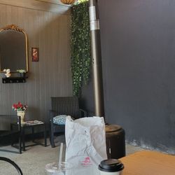 Orion Coffeehouse - In the outside covered lounge, outdoor heater, pleasant ambiance, music, and theme. Texas breakfast burrito, Americano, and water.