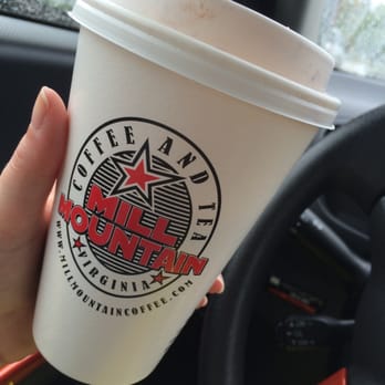 Mill Mountain Coffee & Tea - a hand holding a coffee cup - Coffee & Tea Near Me - Daleville, Virginia