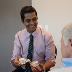 North Texas Oral & Facial Surgery - Dr. Ganti discusses a treatment plan with a patient.