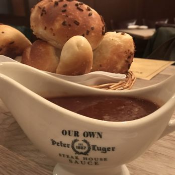 Peter Luger - Foreground: Signature steak sauce, Background: signature onion bread - Steakhouses Near Me - Brooklyn, New York Peter Luger - Foreground: Signature steak sauce, Background: signature onion bread - Steakhouses Near Me - Brooklyn, New York