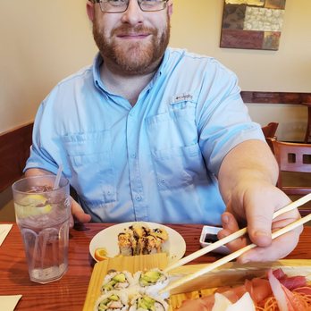 Chopstix - He literally didn't stop reaching for a piece as I'm taking the picture. I can't blame him, it's that good. At least he smiled:) - Asian Fusion Near Me - Winston-Salem, North Carolina