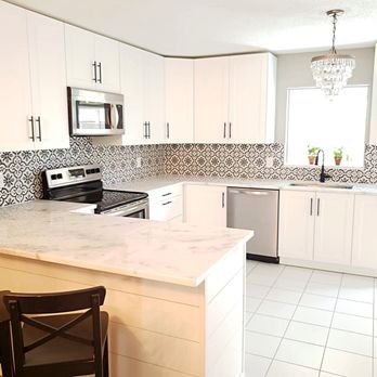 The Kitchen Installers - a clean kitchen with white cabinets - General Contractors Near Me
