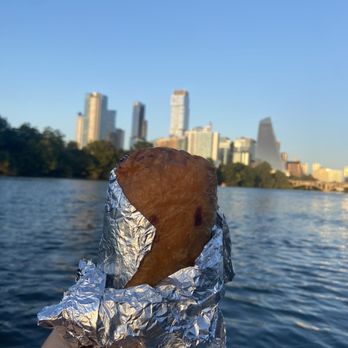 Cabo Bob's Burritos - a hand holding a piece of food - Tacos Near Me - Austin, Texas Cabo Bob's Burritos - a hand holding a piece of food - Tacos Near Me - Austin, Texas
