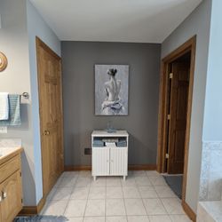 Laura's Interiors - changed the wall color to bring out the painting  and enhance the area. the customer wanted the room to be designed around the painting.