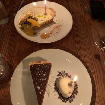 Heirloom - Caramel tart and blood orange semifreddo adorned with candles for our anniversary - New American Near Me - Lewes, Delaware Heirloom - Caramel tart and blood orange semifreddo adorned with candles for our anniversary - New American Near Me - Lewes, Delaware