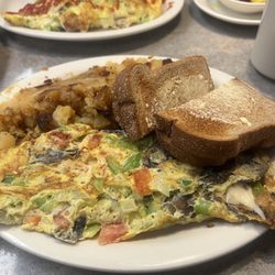 Veggie omelette wheat toast with butter home fries very good. They use three eggs per omelette so it was very fulfilling.