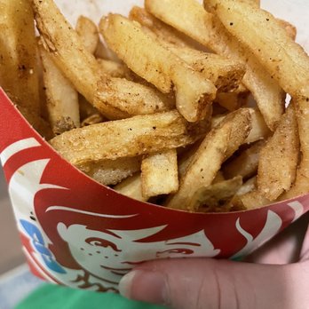 Wendy's - a hand holding a basket of french fries - Fast Food Near Me - Wichita, Kansas Wendy's - a hand holding a basket of french fries - Fast Food Near Me - Wichita, Kansas
