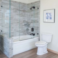 Schicker Luxury Shower Doors, Inc. - This custom shower enclosure features oil rubbed bronze hardware that matches the bathroom's fixtures.