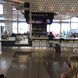 a woman sitting at a table in an airport