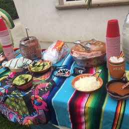 Table with aguas frescas, rice, beans and salsas Table with aguas frescas, rice, beans and salsas