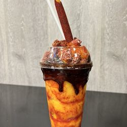 Flores Munchies - Chamoy lovers , base is a fruit freeze of your choice topped with chamoy sauce and chamoy candy and chamoy straw