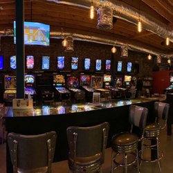 Pinball machines line the wall.