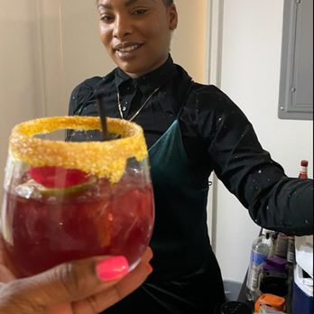 Wetbar Events - a woman holding up a drink - Bartenders Near Me Wetbar Events - a woman holding up a drink - Bartenders Near Me