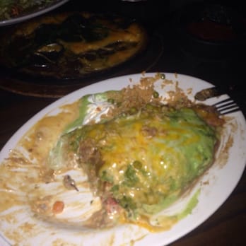 Juanito's II - Half of my chimichanga. I couldn't get a picture fast enough it was so good. - Mexican Near Me - Howell, New Jersey