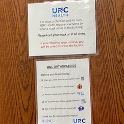 UNC Orthopaedics - Reminders on exam room door. Note: masks are no longer required, only recommended.