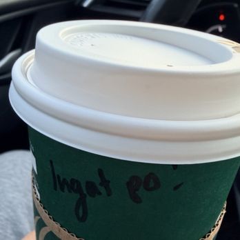 Starbucks - My coffee with a great note. - A Starbucks coffee cup with a handwritten note is held inside a vehicle, with the car's interior and dashboard visible. - Coffee & Tea Near Me - Schaumburg, Illinois