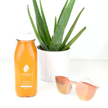 Renew Cold Press - a bottle of orange juice and sunglasses - Juice Bars & Smoothies Near Me - Ottawa, Ontario Renew Cold Press - a bottle of orange juice and sunglasses - Juice Bars & Smoothies Near Me - Ottawa, Ontario