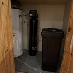 WaterMart - black Clack WS1 Water Softener (back), black brine tank (front)
