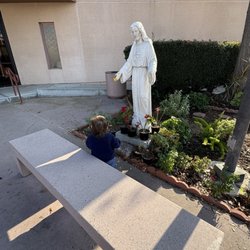 Our Lady of Lourdes Church - Jesus statue & prayer bench in the courtyard