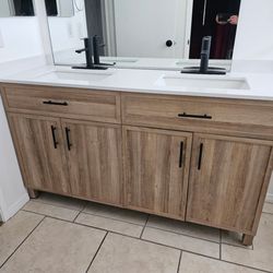 New 60 Inch Double Sink Vanity. New Handles and Faucets, new Mirrors and Medicine Cabinet.