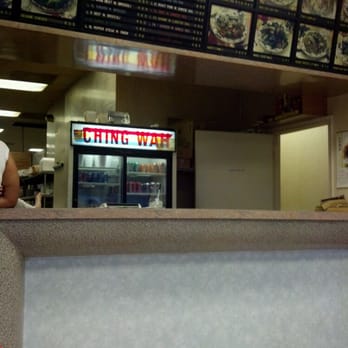 Ching Wah - a man sitting at a counter in a restaurant - Chinese Near Me - Chesterfield, Virginia