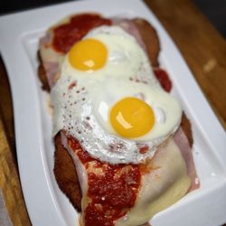 Manolo - Napolitana with fried egg chicken Milanese comes with a side of veggies, fries, or salad
