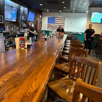 Snuffers - a long wooden bar with chairs - Burgers Near Me - Addison, Texas Snuffers - a long wooden bar with chairs - Burgers Near Me - Addison, Texas