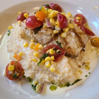 The Kill Devil Grill - Grilled Rockfish over Stone Ground Cheese Grits with Heirloom Tomato Salsa. - American Near Me - Kill Devil Hills, North Carolina The Kill Devil Grill - Grilled Rockfish over Stone Ground Cheese Grits with Heirloom Tomato Salsa. - American Near Me - Kill Devil Hills, North Carolina