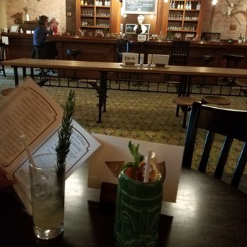 Montgomery Distillery - A  cabana hammock on right and a honey bee highball on left - Bars Near Me - Missoula, Montana