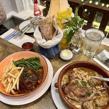 Chez Philippe - Chicken with wine and slow cooked beans with pork, sausage, and duck confit. Both are classic French dishes and taste great! - French Near Me - Los Gatos, California