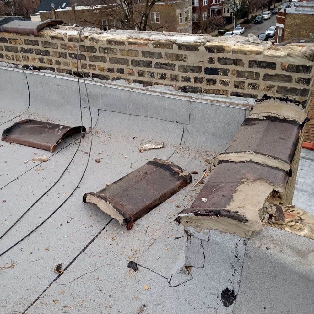 Capital Roofing Construction - Copings that Capital had attached less that 2 years prior, just flying off the parapet walls like they were attached with glitter glue - Roofing Near Me Capital Roofing Construction - Copings that Capital had attached less that 2 years prior, just flying off the parapet walls like they were attached with glitter glue - Roofing Near Me