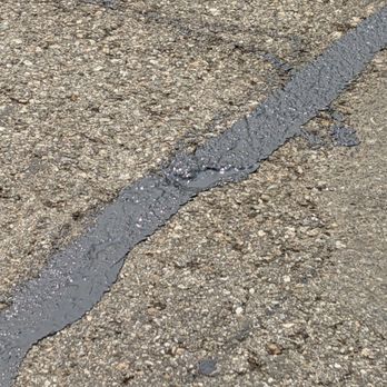 Elias Bros Contractors - a close up of a drain on a road - Masonry/Concrete Near Me - Pomona, California