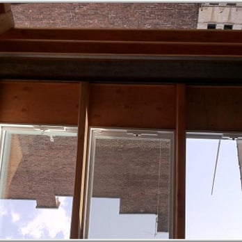 S. Towers - a view of a building through a window - Roofing Near Me - Brooklyn, New York