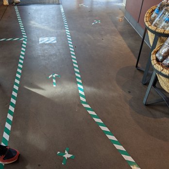 Starbucks - a person standing on the floor in front of a coffee shop - Coffee & Tea Near Me - Kelso, Washington