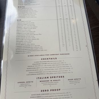 Antico Posto - Ahh cocktails I highly recommend the weekend Weekend in Amalfi - The menu includes sections for sparkling and rosé wines, white wines, red wines, and cocktails, with detailed descriptions and prices. It also features Italian spritzers and zero-proof drinks, with a clean, organized layout on a white background and black text. The menu is placed on a dark table surface, with part of a cup visible in the top left corner. - Italian Near Me - Oak Brook, Illinois